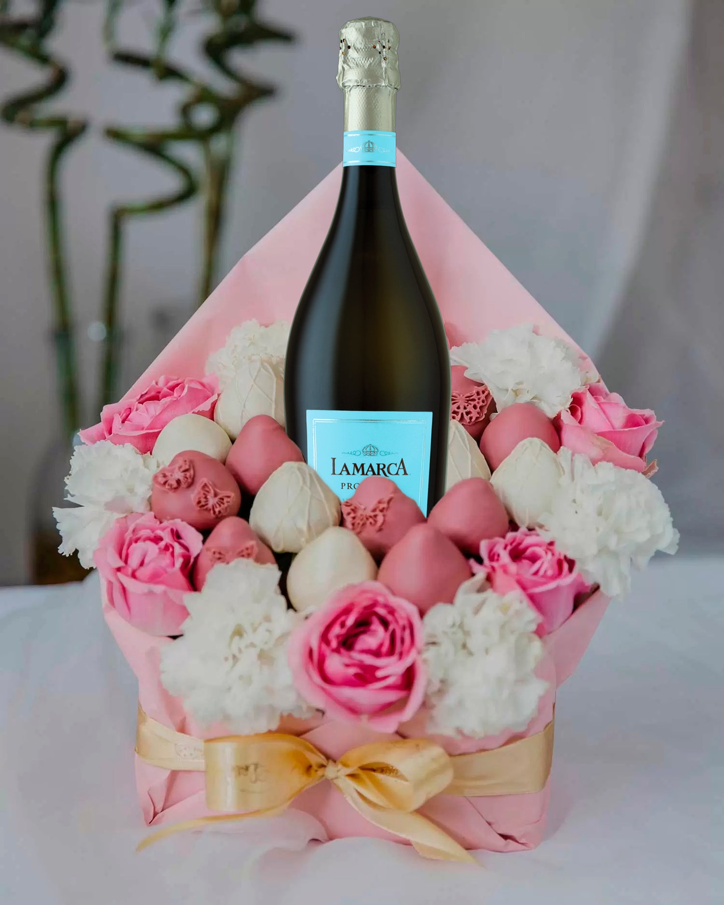 Pink Belgian chocolate-covered strawberry bouquets and a bottle of exclusive